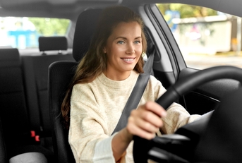 Smiling woman driving a car