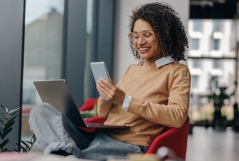 Smiling woman using a phone