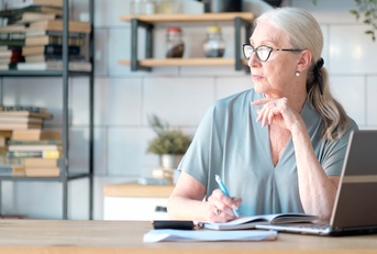Senior woman using laptop for websurfing