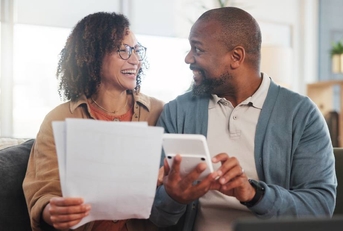 happy man and woman with paperwork budget and retirement fund with investment
