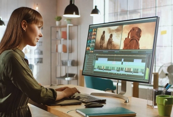 Female Video Editor Works with Footage in Work Office