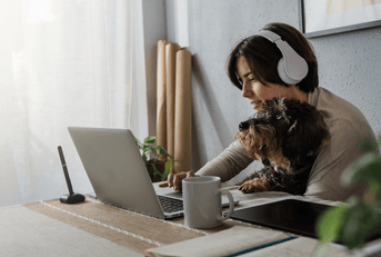 person listening to music on laptop