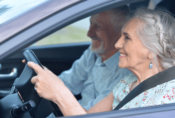 senior couple driving car