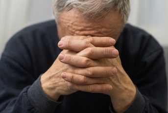 worried senior man praying