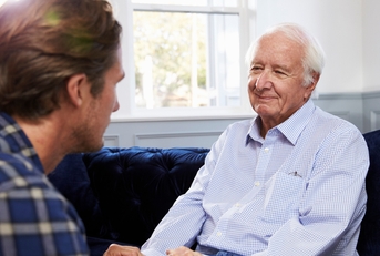 adult son talking to his father