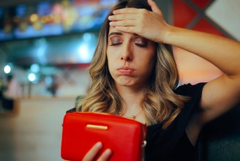 Unhappy Restaurant Client Checking her Empty Wallet