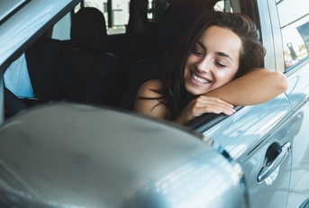 woman sitting in new vehicle