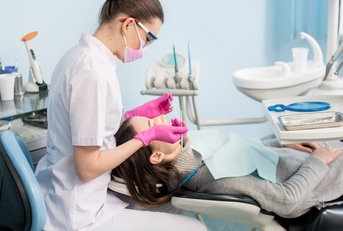 female dentist with dental tools