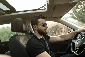 mid-30s person driving car