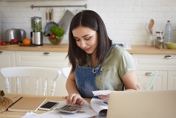 woman doing calculations managing home budget