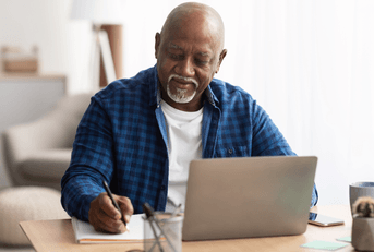 person in their 60s at laptopa