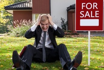 Irate man sitting on grass