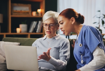 old woman with nurse on sofa