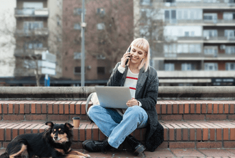 person working outdoors on laptop