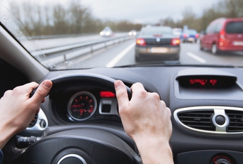 close up of hands on steering wheel