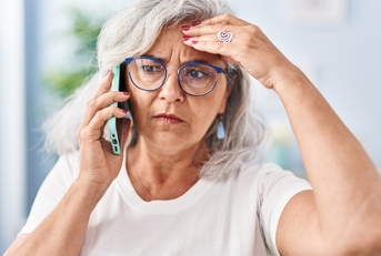 woman worried talking on the smartphone