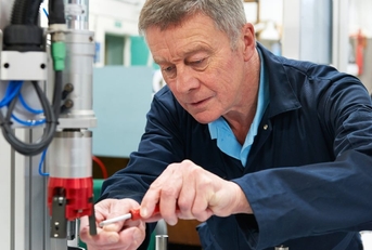 engineer working on machine in factory