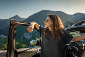 person standing in open car door