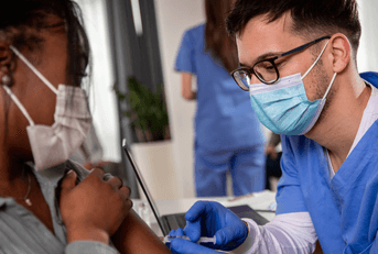 nurse vaccinating patient