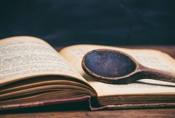 wooden spoon on a vintage book