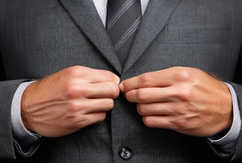 Hands buttoning a suit