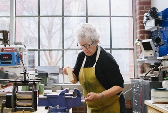 art jeweler working in studio