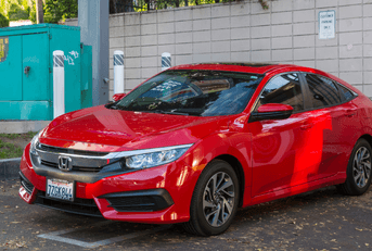 red honda civic in a parking lot