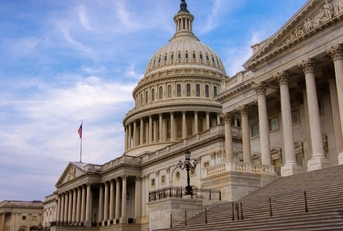 Low angle view of the east entrance to United States Capitol building in Washington DC with marble dome and stairs