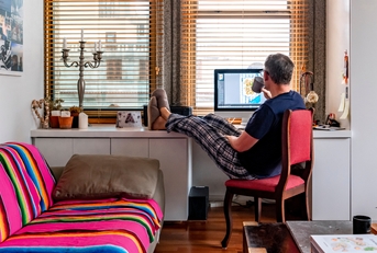 A man drinking coffee while working from home
