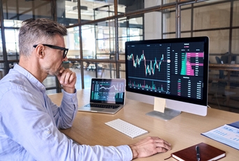 businessman analyzing stock market trading graphs report