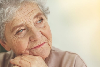 Close-up of an elderly woman with a reflective look on her face