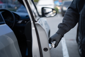thief opening car door
