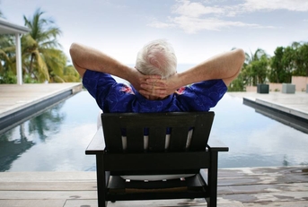 Senior man relaxing by the pool