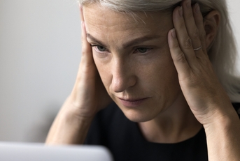 stressed woman working using laptop
