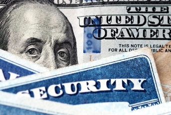 social security cards with dollar bill