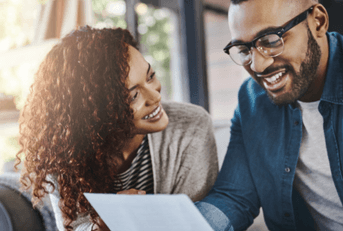 Smiling couple working on bills