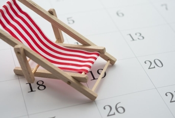 Red beach chair on white blank calendar background copy space. 