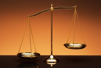 balance scale on orange background