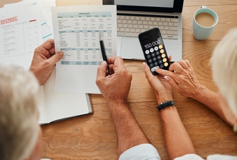 senior couple calculating their expenses