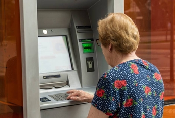 Senior woman is using an ATM