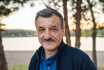 Close up of cheerful male standing looking to the camera