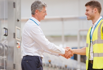 supervisor and worker shaking hands