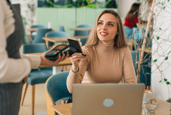 person paying bill at restaurant