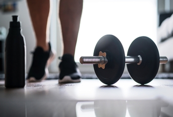 Man starting to exercise with dumbbell