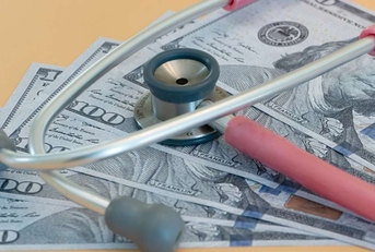 stethoscope laying on us bills