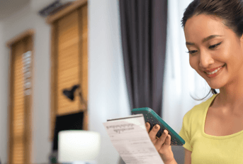 person paying bills on phone