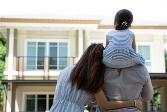 happy family in front of their new house
