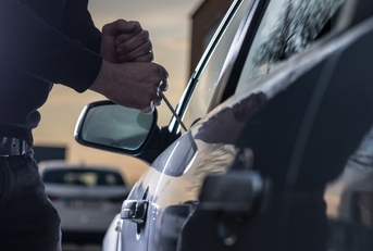 auto thief in black balaclava