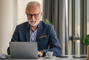 senior businessman working on laptop