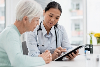 senior woman with doctor for consultation